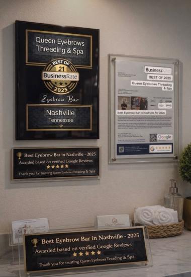 Queen Eyebrows Threading and Spa award plaques displayed at the front desk of the spa